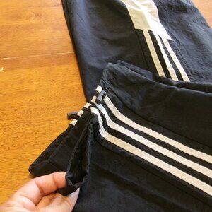 Three striped black and white track suit pants